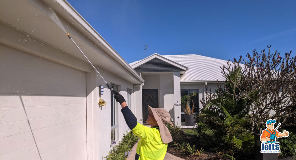 Exterior house clean, pressure washing gutters and walls